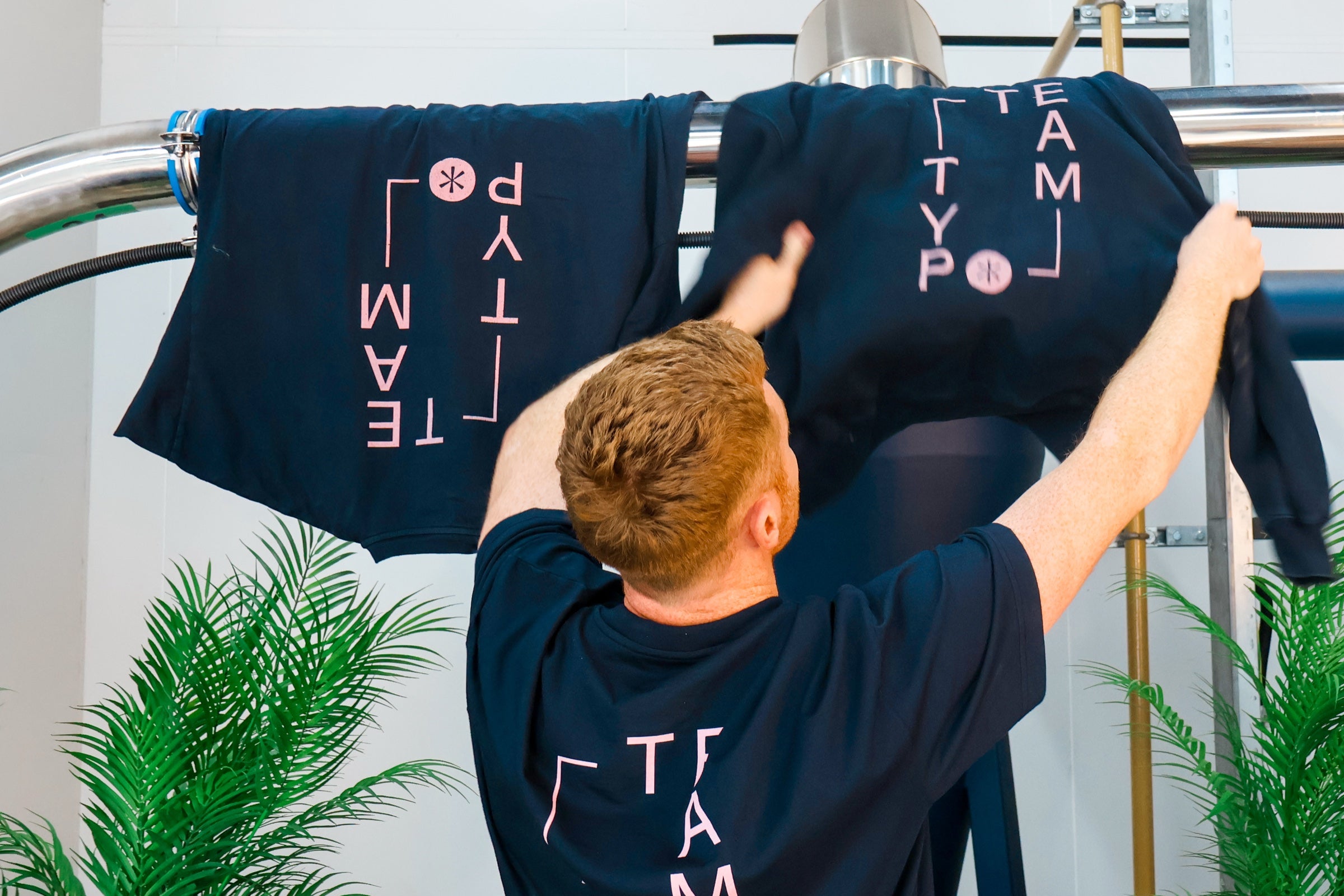 Typo Coffee team hanging branded shirts inside the Mullingar roastery
