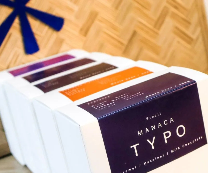 A row of Typo coffee cartons, Manaca at the front